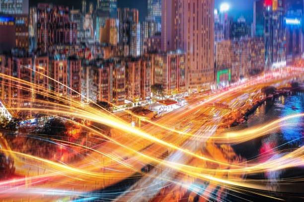 istock Hong Kong cityscape with bright lights at night.  Light trails stream through the air, creating a sense of motion. 2178444593