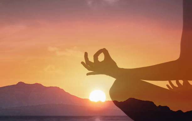 istock Woman meditating in beautiful sunrise settings. 2178444945