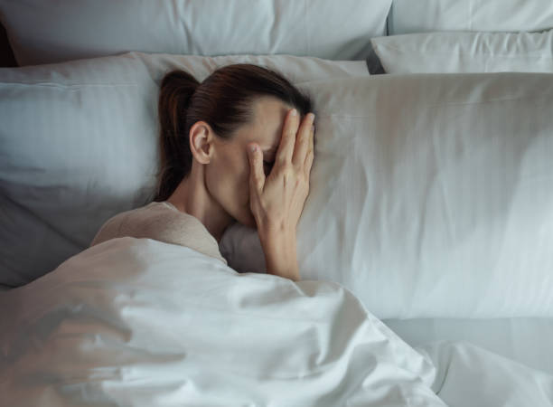 istock Woman lying in bed feeling tired and stressed. 2178445006