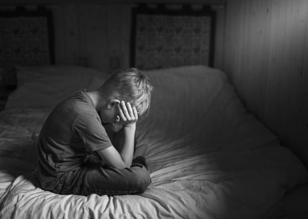 istock Sad little boy in the bedroom. 2178445078