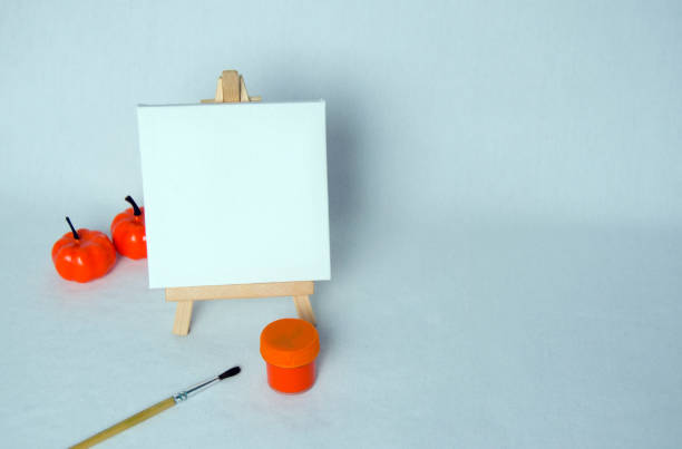 Mini easel with white blank canvas. Art concept.Halloween concept. Autumn concept. White background.