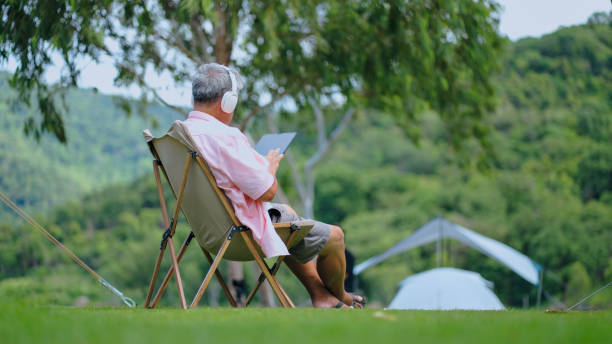 istock Senior man using tablet traveling and Camping summer Holiday. 2178453380