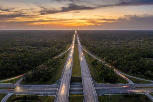 istock Highway intersection in Florida rural area at sunset. Elevated interchange lanes for express passing of car traffic 2178454379