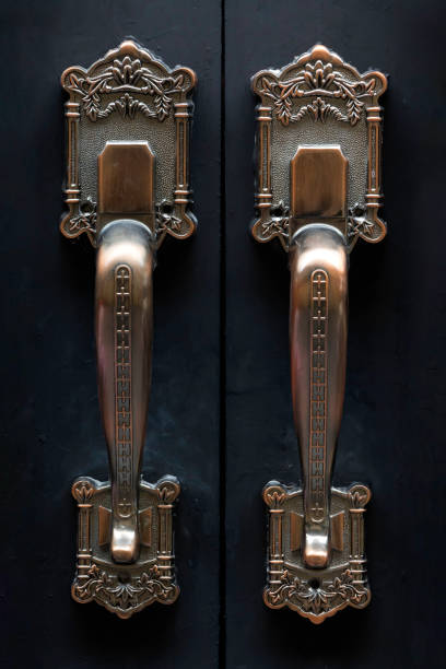 istock A black iron door with a vintage decorative door handle. 2178461990