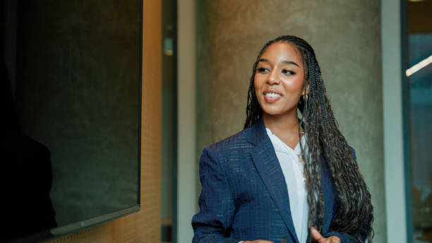 istock Young Afro-Asian woman making a project presentation and using visual aids for teammates to understand easily. 2178469150
