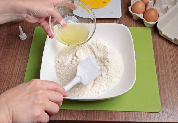 istock Process of making dough. Woman mixed powdered sugar, almond flour and egg white with silicone spatula in bowl. 2178470100