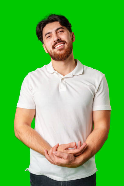 istock A man with a beard smiles confidently against a bright green background 2178471647