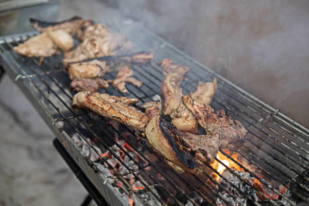 The pork is roasted on the grill as it smokes.
