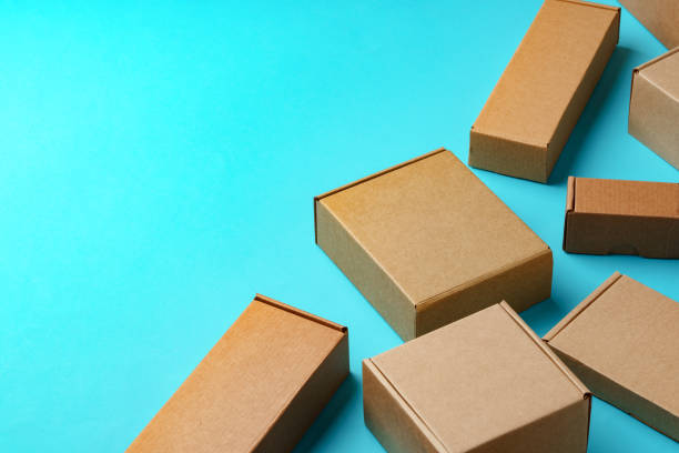 istock A collection of cardboard boxes arranged on a bright blue surface 2178471837