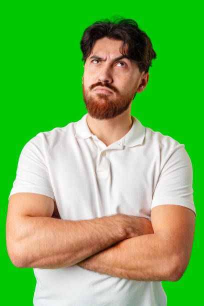 istock A man contemplates thoughtfully against a bright green background 2178472264