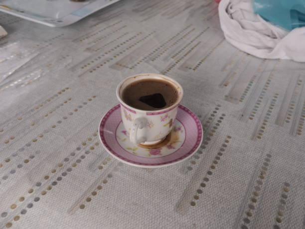 istock A small, porcelain cup with a pink floral pattern sits on a matching saucer, filled with a turkish coffee 2178476058