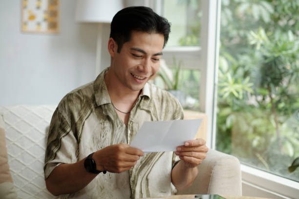 istock Man Reading Letter With Good News 2178477497