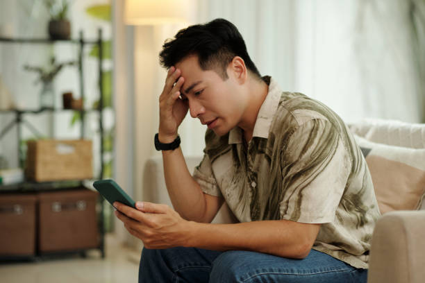 istock Upset Man Reading Message On The Phone 2178477615