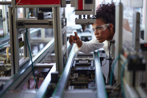 istock Young black scientist working on machinery in a lab. 2178477745