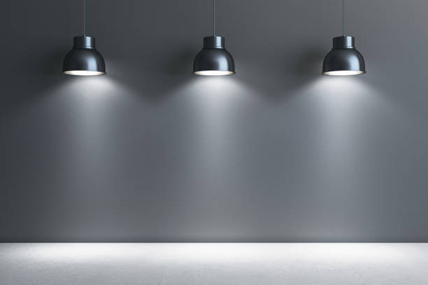 istock Modern interior with pendant lamps illuminating a blank wall space for presentations and exhibits. 3D Rendering 2178478037
