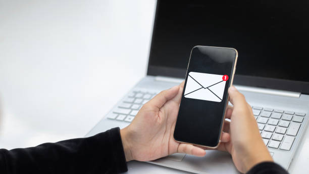 istock A person is holding a cell phone and laptop 2178478457