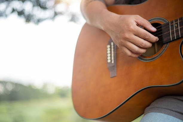 istock A person is holding a guitar and playing it 2178478460