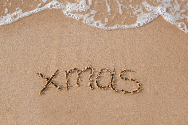 istock Xmas written on sandy beach sea. Top view. Flat lay. 2178478565