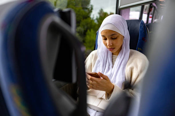 istock Young female refugee text messaging while sitting in the bus 2178479282