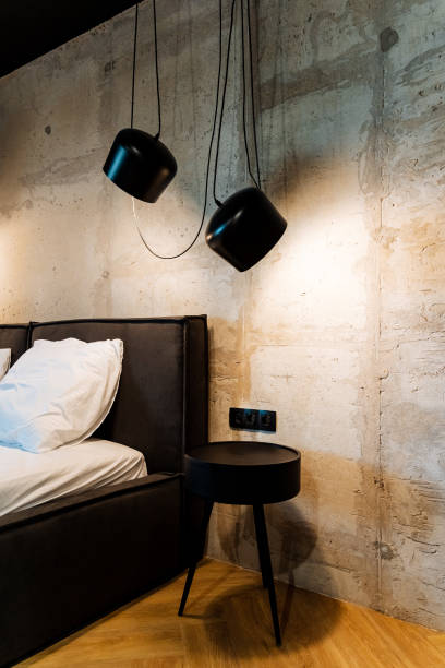 istock Create a modern bedroom with minimalist bedside table, stylish lighting, sleek design, industrial chic, and contemporary elements to achieve a sophisticated look 2178480600