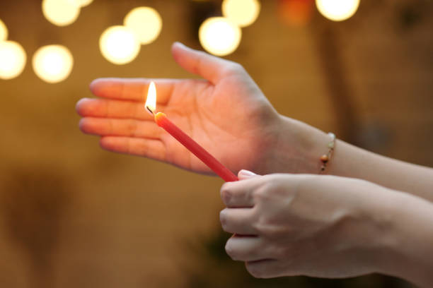 Close-up of woman lightning the candle for holiday