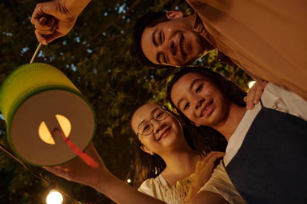 istock Family With Lantern Standing Outdoors 2178480732