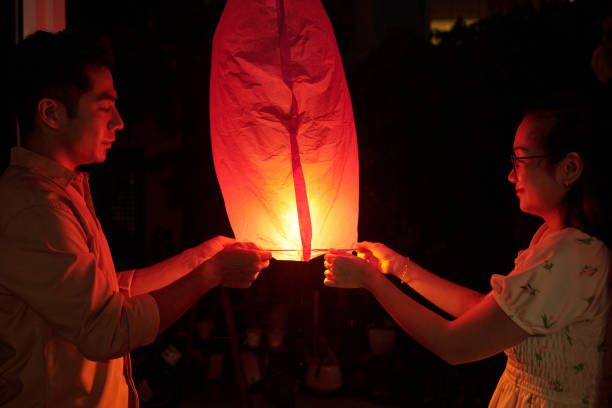 istock Asian Couple Launching Chinese Lantern 2178480915