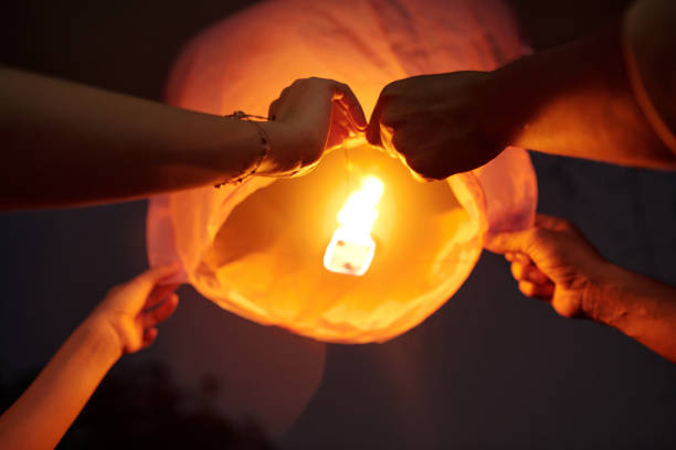 istock Young Couple Launching Lantern In The Sky 2178480947