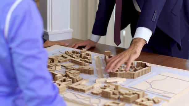 istock Young architect in business suit explaning his new construction project 2178481116