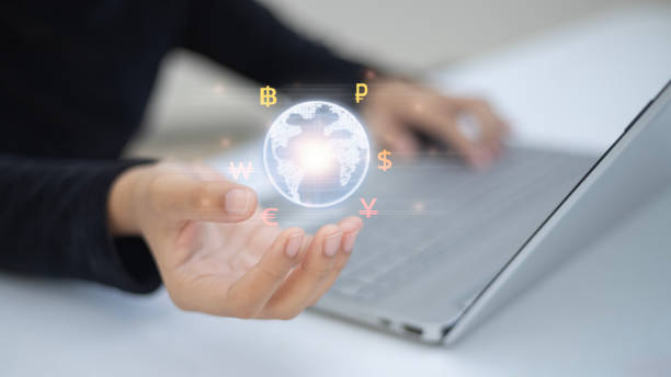 istock A person types on a laptop displaying a globe surrounded by currencies such as the US dollar, euro, and British pound. Symbolizing the global currency exchange. 2178482068