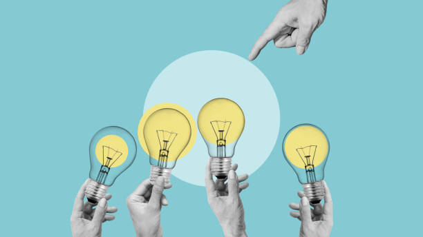istock Brainstorming Ideas to work Business Meeting Brainstorm. A group of hands extends upward, grasping light bulbs 2178482277