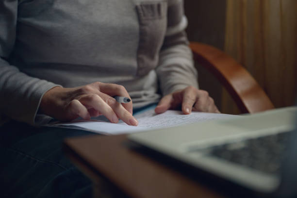 istock Female freelancer doing paperwork in home office interior 2178482283
