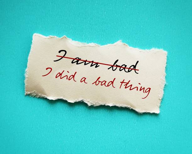 istock Torn stick note on red background with handwritten text I AM BAD changed to I DID A BAD THING, to overcome low self worth , take responsibility for mistakes, but not self degrade 2178482675