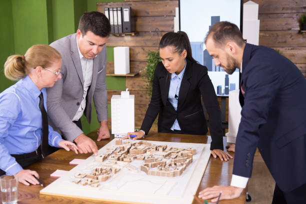 istock Female architect in business suit with team of construction engineers 2178483005