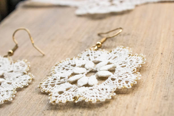 istock delicate lace earrings on wooden surface 2178483017