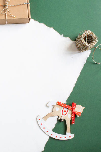 istock christmas gift wrapping with cardboard box, decorative twine and rocking horse 2178483059