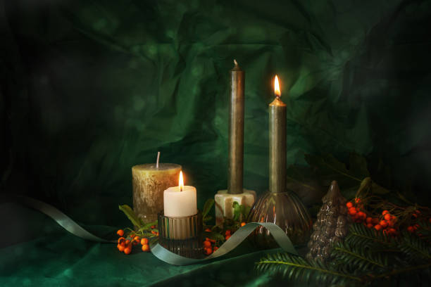 istock Second Advent, four candles, two are lit, Christmas decoration, twigs, red orange berries and a ribbon, dark green background, holiday concept, copy space, selected soft focus 2178483599