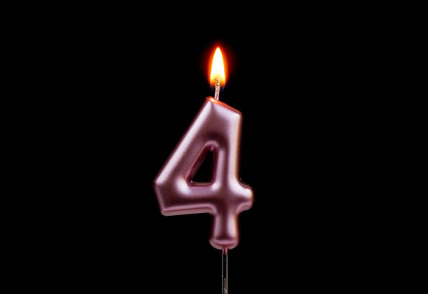 Burning pink birthday candle isolated on black background, number 4