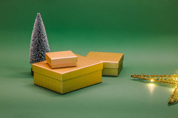 istock Christmas gift boxes and tree with lights. Christmass decoration on green background 2178486057