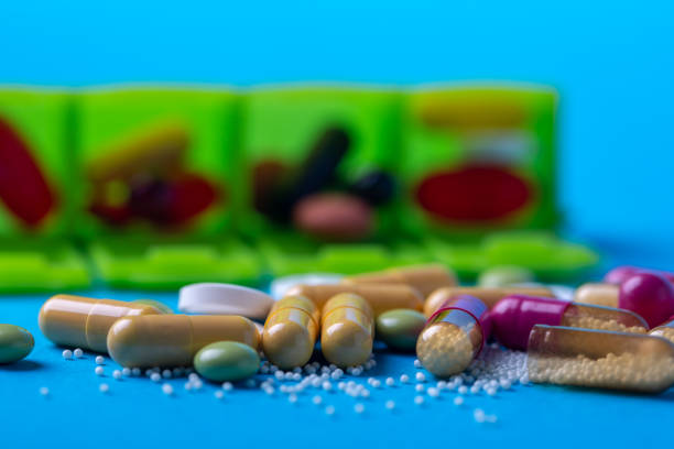 istock Top view with multicolored pills and capsules and in the back you see an organizer 2178488165