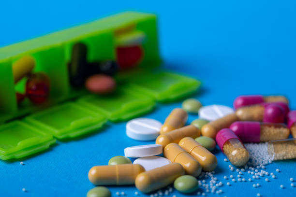 istock Close up with multicolored pills and capsules. Organizer in the back 2178488442