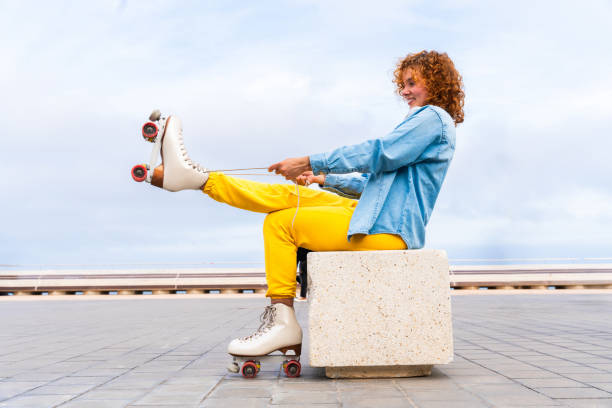 istock Beautiful red haired young woman with rollerskates having fun outdoors 2178488768