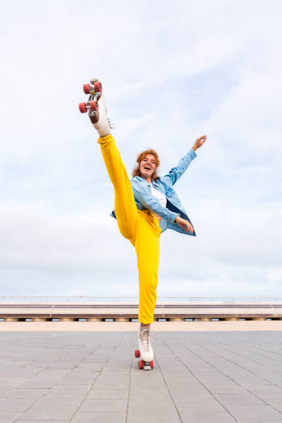 istock Beautiful red haired young woman with rollerskates having fun outdoors 2178488793