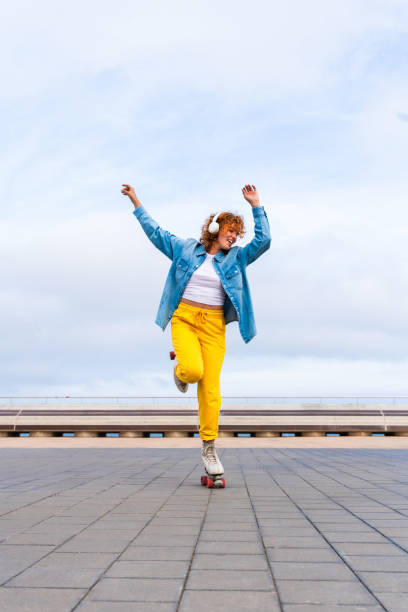istock Beautiful red haired young woman with rollerskates having fun outdoors 2178488867