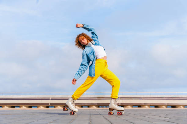 istock Beautiful red haired young woman with rollerskates having fun outdoors 2178488986