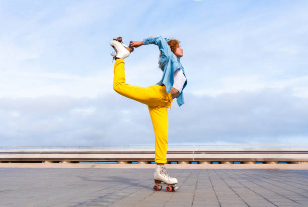 istock Beautiful red haired young woman with rollerskates having fun outdoors 2178489084
