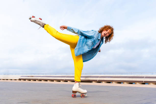 istock Beautiful red haired young woman with rollerskates having fun outdoors 2178489408
