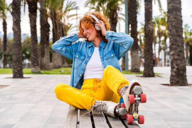 istock Beautiful red haired young woman with rollerskates having fun outdoors 2178489558
