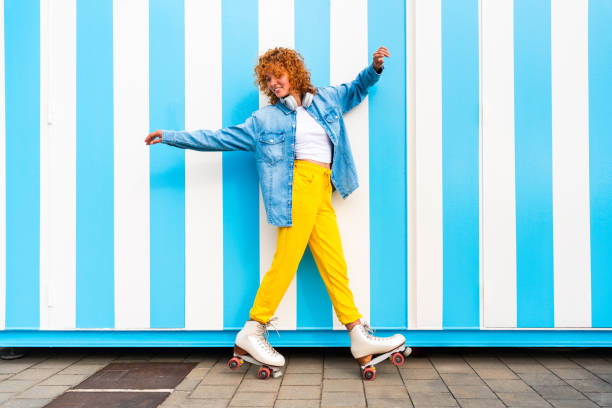 istock Beautiful red haired young woman with rollerskates having fun outdoors 2178489723