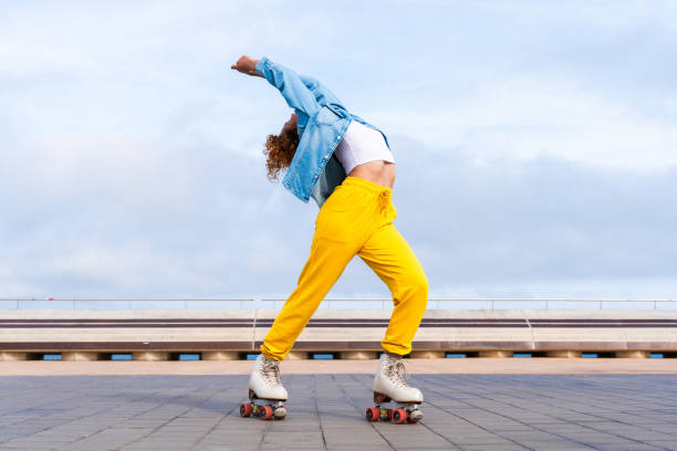 istock Beautiful red haired young woman with rollerskates having fun outdoors 2178489955